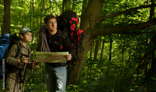 Father and son hiking in forest