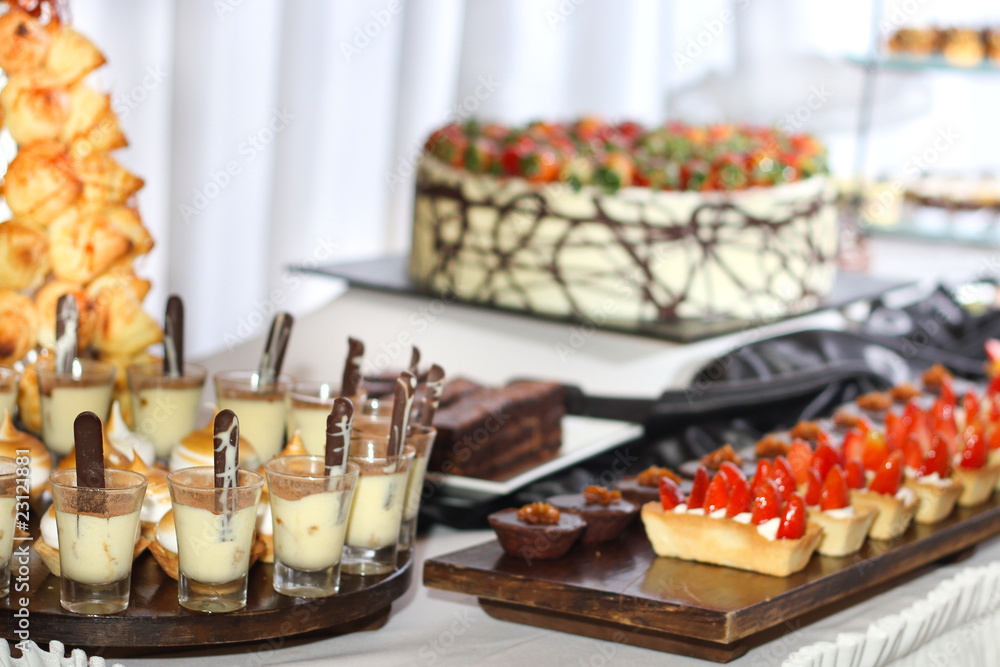 Row of individual serving of desserts whit strawberry