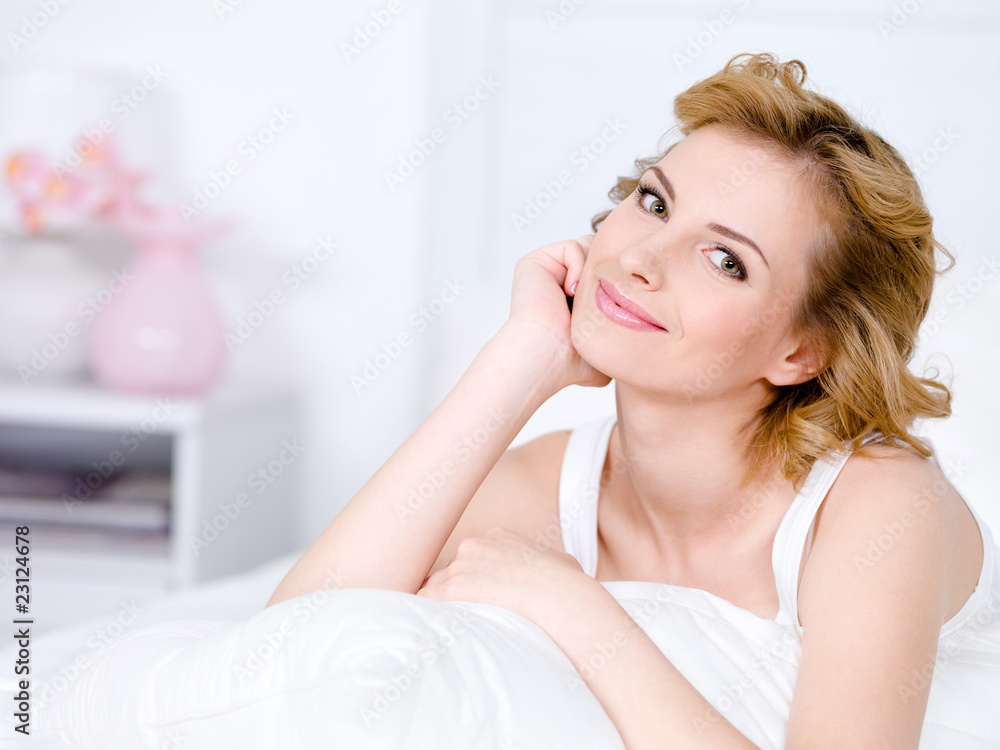 Portrait of smiling relaxing woman at bedroom Portrait of smiling relaxing woman at bedroom