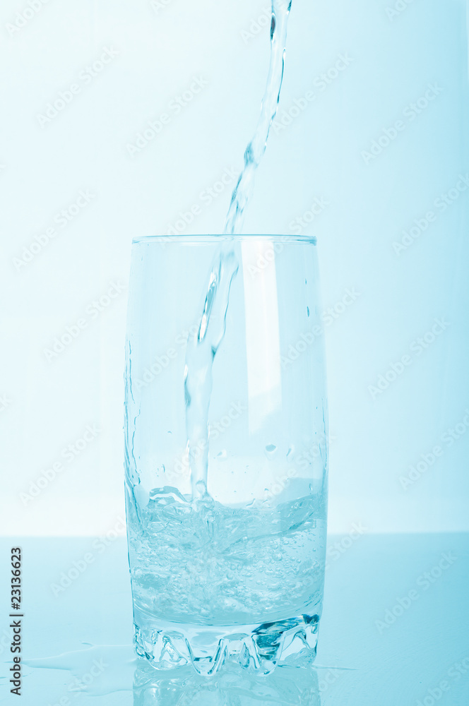 Glass of pouring water