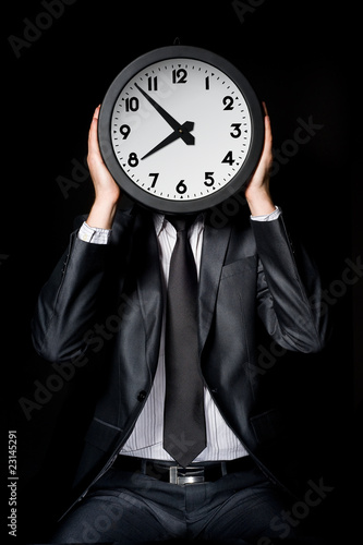 man holding clock photo