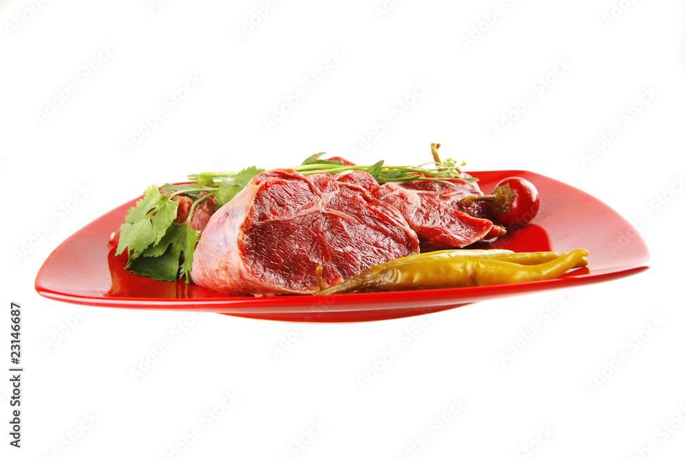 uncooked meat medallion on red