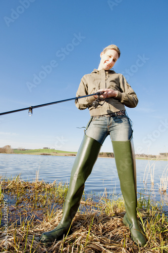 woman fishing at a pond photo