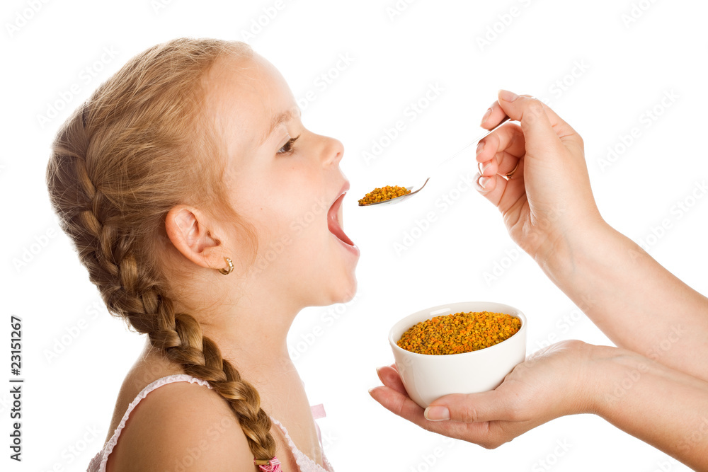 Little girl taking pollen - traditional remedies Little girl taking pollen - traditional remedies
