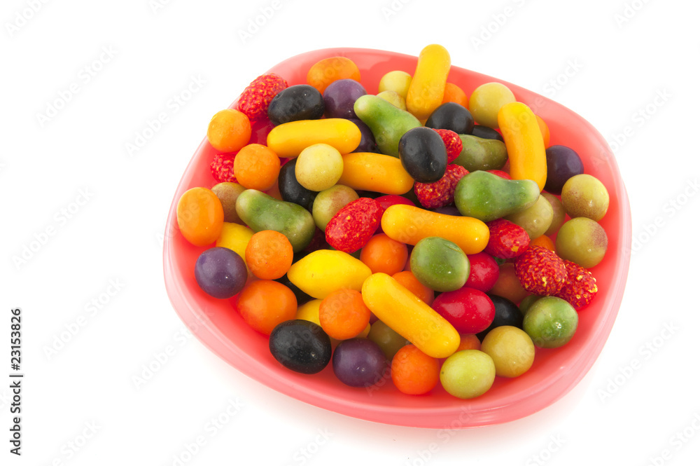 Colorful candy on pink plate