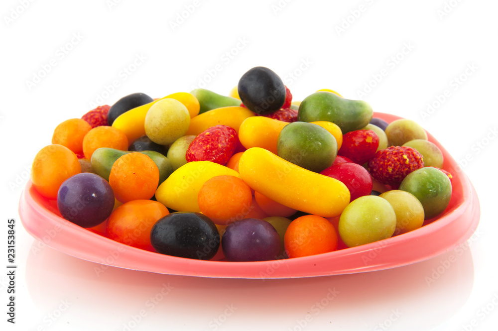 Colorful candy on pink plate