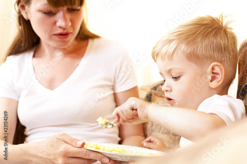 mother feeding her son