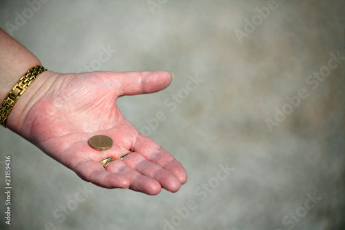 showing a pound coin asking for assistance © Tony Baggett