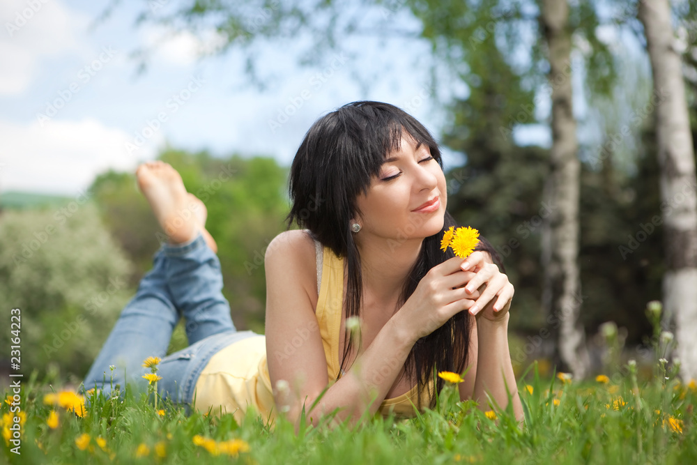 Cute woman in the park with dandelions Cute woman in the park with dandelions