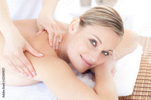 Smiling woman receiving a back massage