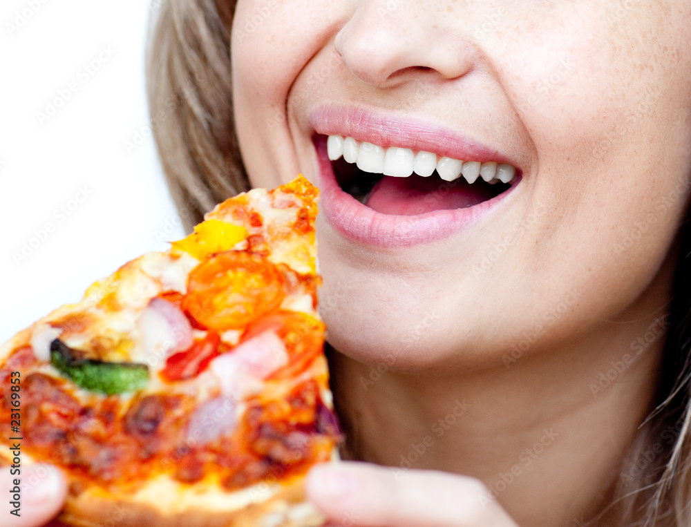 Close-up of a smiling woman eating a pizza