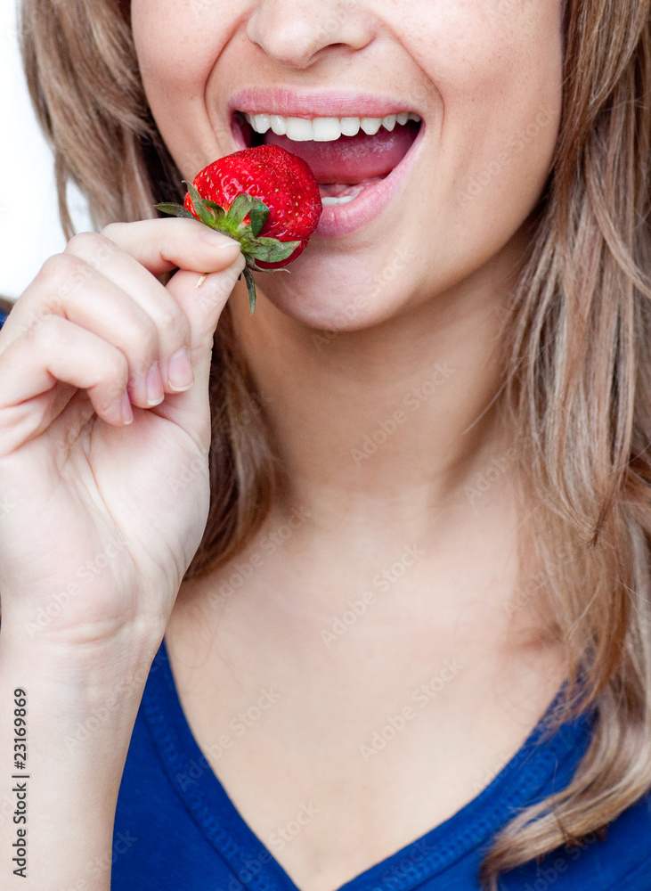 Close-up of a woman eating a strawberry Close-up of a woman eating a strawberry