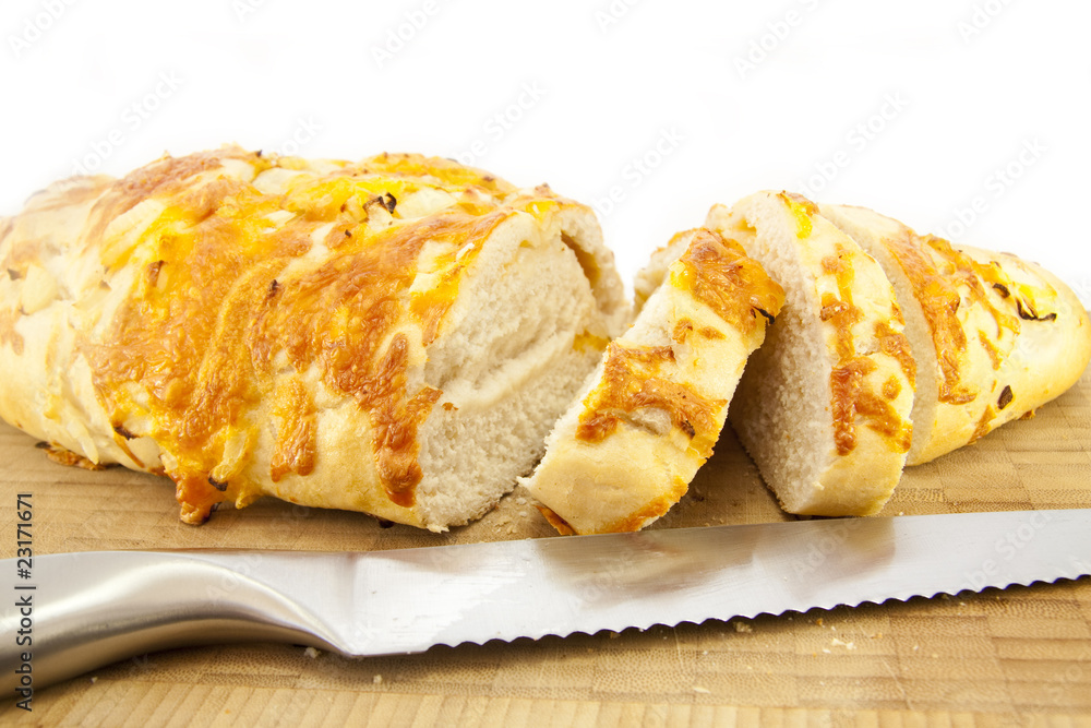 Cheese and Onion Bread on a wooden cutting board with a Knife Cheese and Onion Bread on a wooden cutting board with a Knife