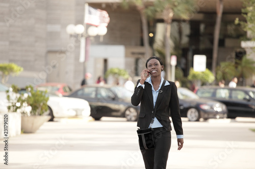 Businesswoman walking and talking on the phone