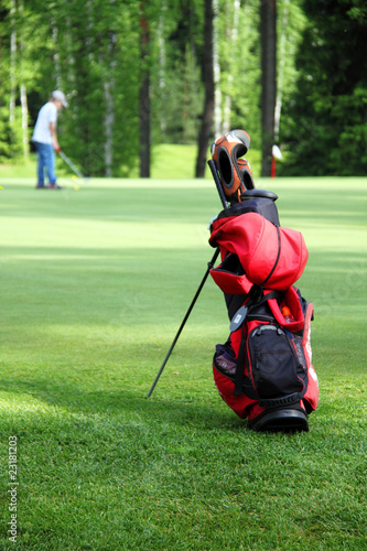 Bag with golf clubs on the golf field