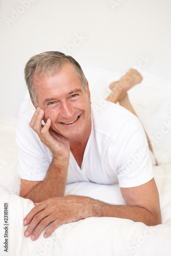 Senior Man Relaxing On Bed