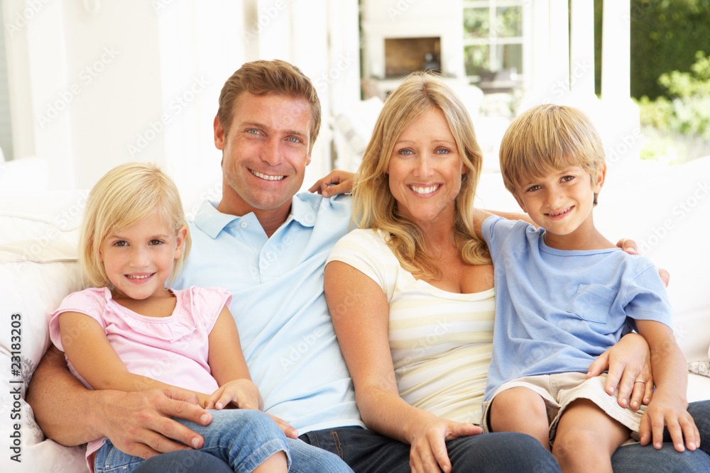 Portrait Of Young Family Relaxing Together On Sofa Portrait Of Young Family Relaxing Together On Sofa