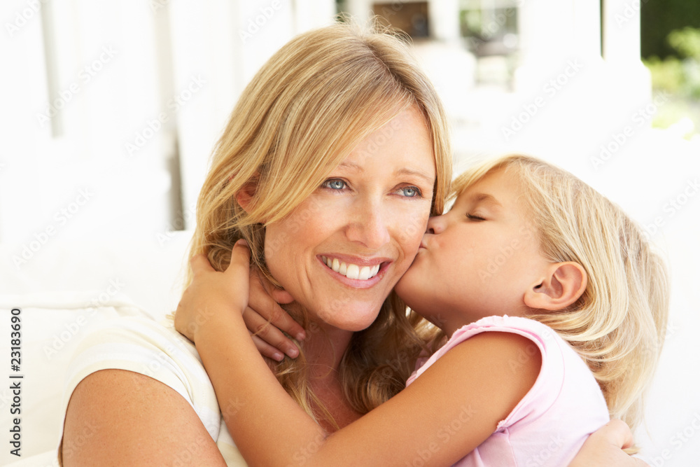Daughter Giving Mother Kiss Relaxing On Sofa Daughter Giving Mother Kiss Relaxing On Sofa