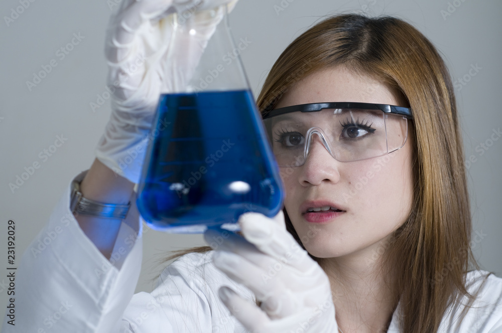 Young research assistant doing experiment Young research assistant doing experiment