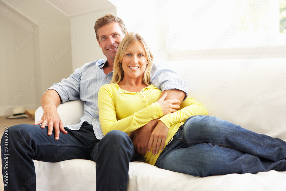 Couple Relaxing On Sofa At Home Couple Relaxing On Sofa At Home