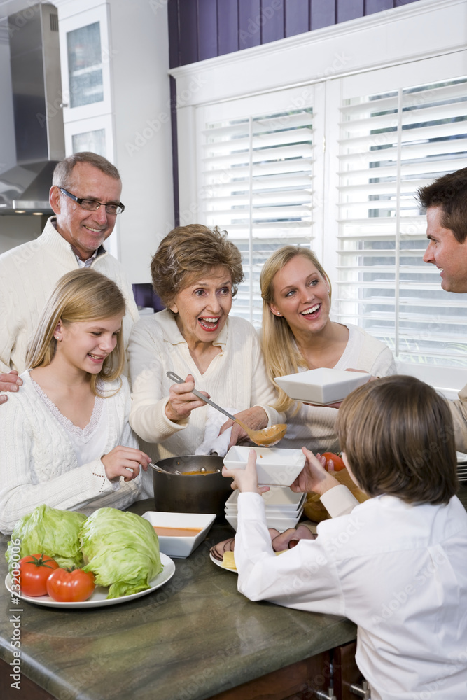 Three generation family in kitchen eating lunch