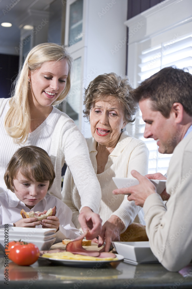 Grandmother with family eating lunch in kitchen