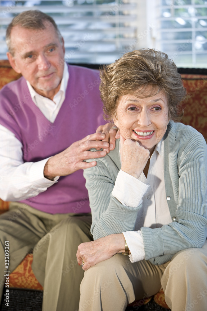 Senior couple sitting together, focus on woman