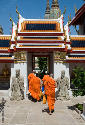 Monks and stone statues in Buddhist temple,Bangkok photo