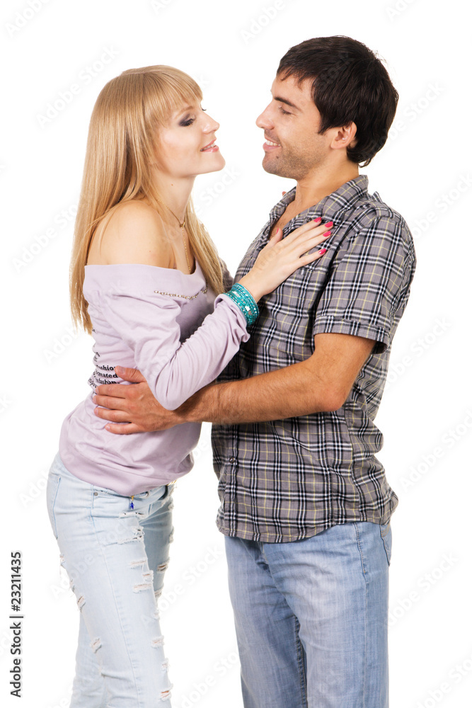Romantic young couple in casual clothing, white background Romantic young couple in casual clothing, white background