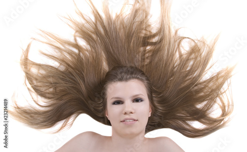portrait of pretty young blonde with beauty hairs lying on the f