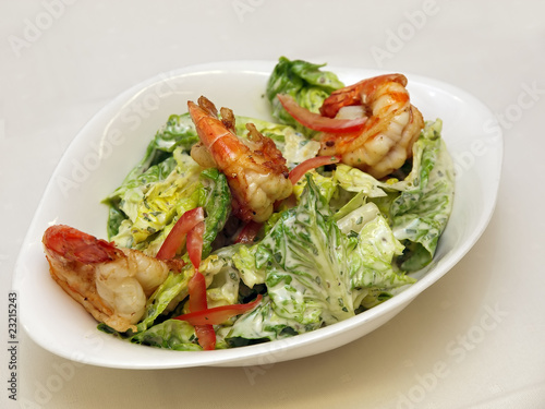 fresh garden salad with grilled prawns on a stylish white bowl