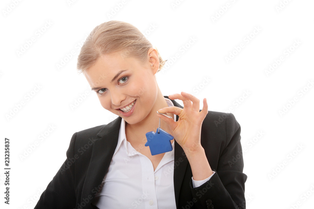 Young businesswoman holding house shaped key chain Young businesswoman holding house shaped key chain