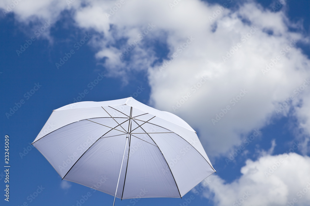 White umbrella under cloudy sky