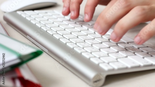 Typing on a white  keyboard