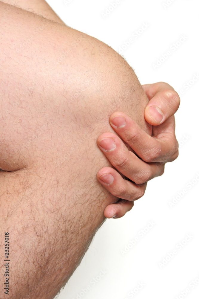 male knee with hand on white background