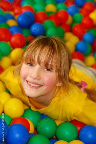 happy girl in ball pool