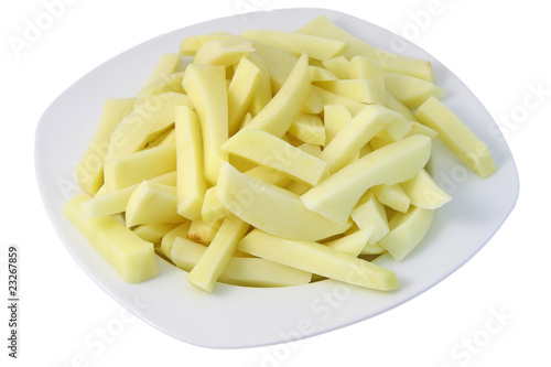 Plate of raw french fries isolated on white