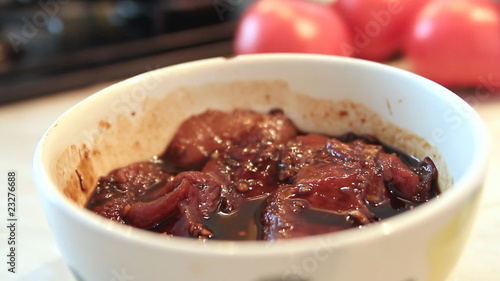 Raw pork sirloin chops in soya sauce with garlic and ginger