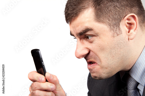 stressed businessman screaming in telephone