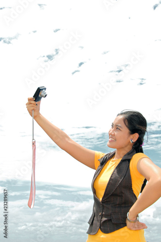 teenage asian girl holding camera