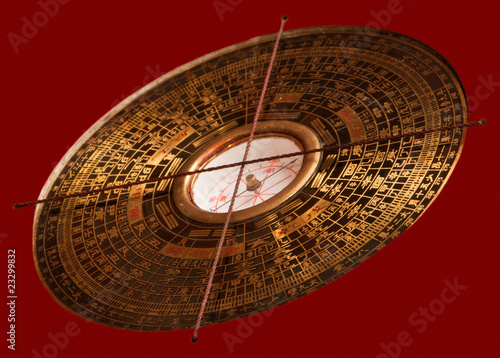 Feng shui compass Luopan on red background. photo