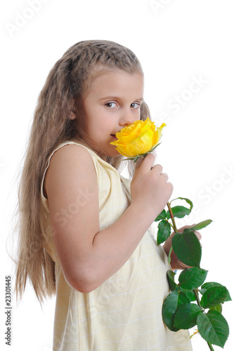 Girl sniffing yellow rose.