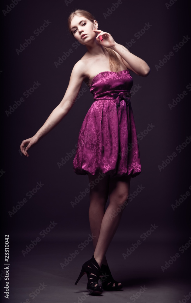 Beautiful young woman wearing pink dress and high heels Beautiful young woman wearing pink dress and high heels