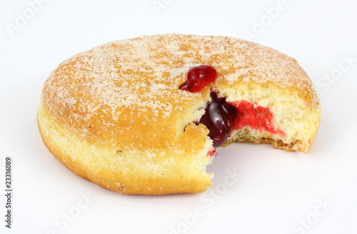 Fresh raspberry filled donut that has been bitten