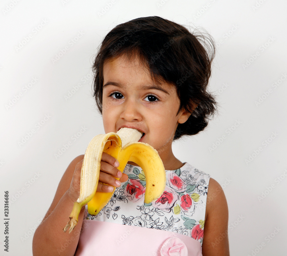 child eating banana