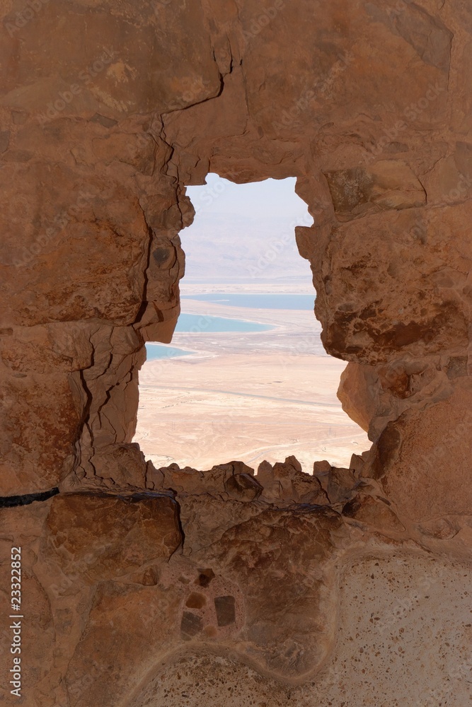 Dead Sea landscape through jagged window