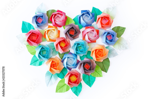 Paper roses arranged in a heart shaped on a white background