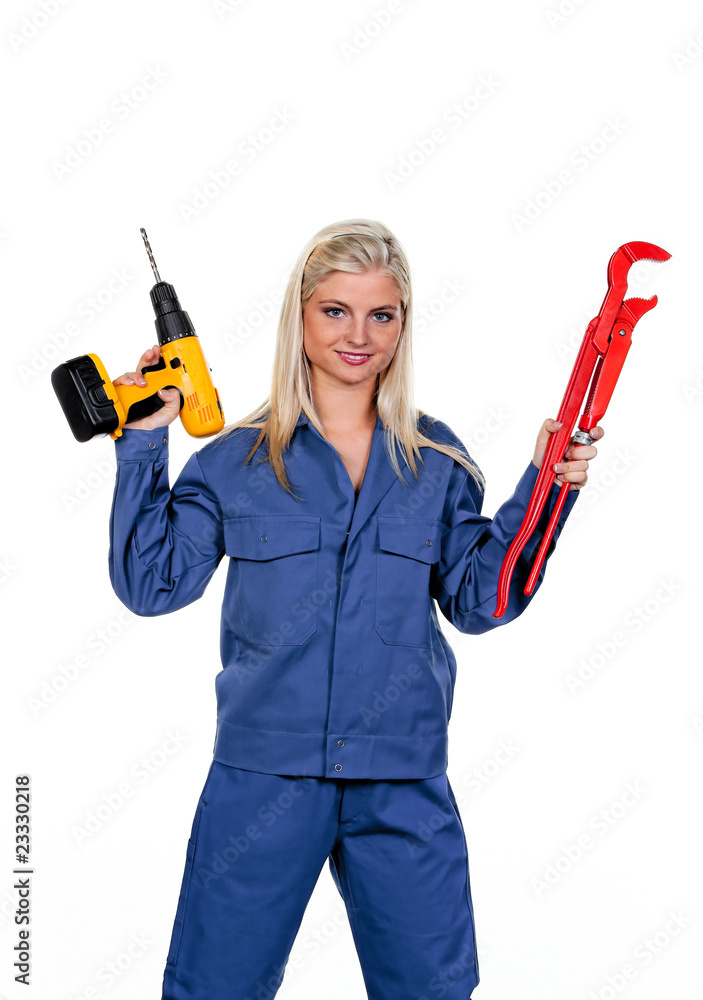 Frau in blauer Arbeits Kleidung mit Bohrmaschine Frau in blauer Arbeits Kleidung mit Bohrmaschine
