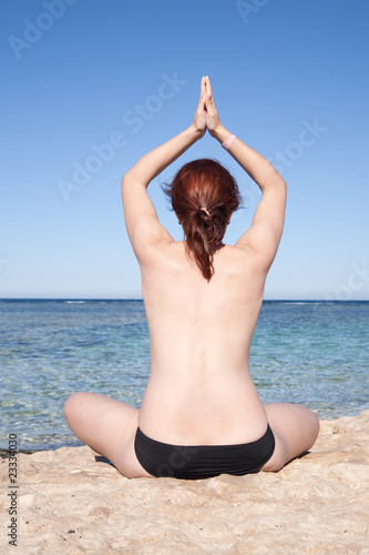 girl practicing yoga at sea