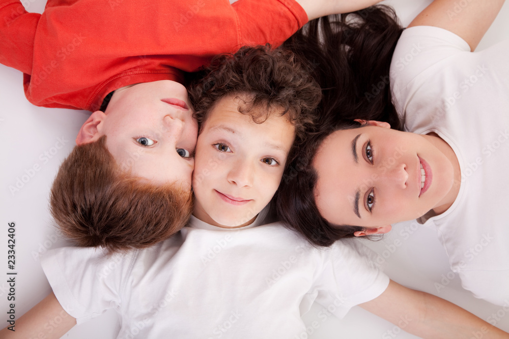 boys with woman, lying on the floor with heads together